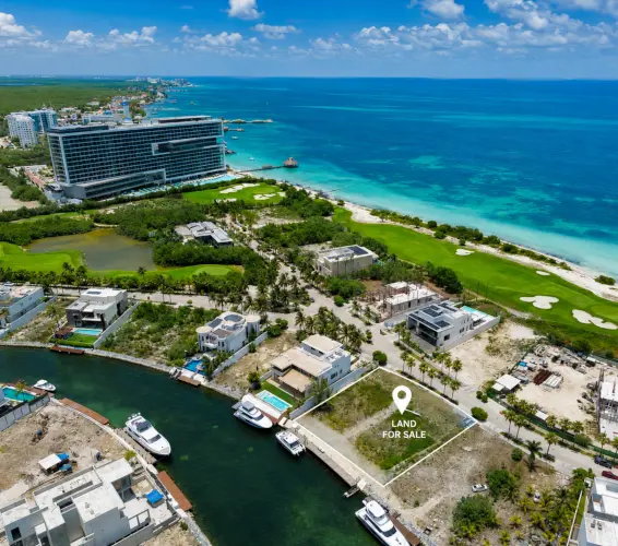 drone image of mexico with pin that says "land for sale" over an empty lot